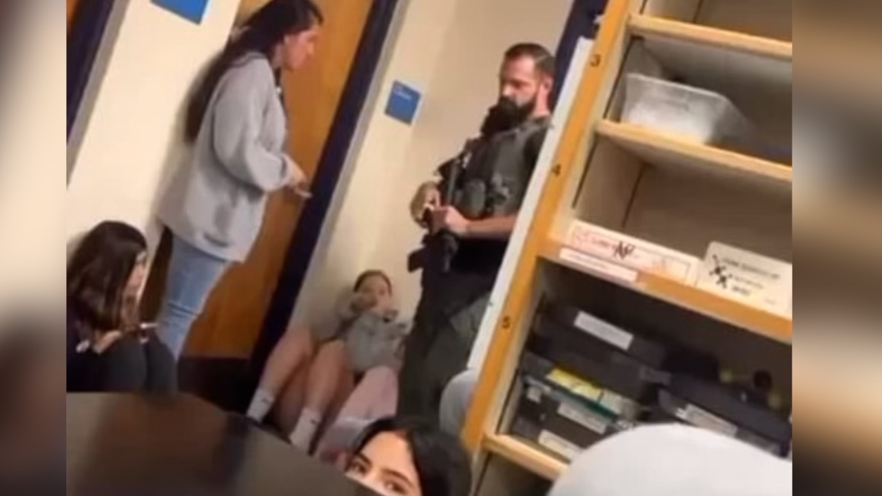 Armed officer entering classroom during swatting incident