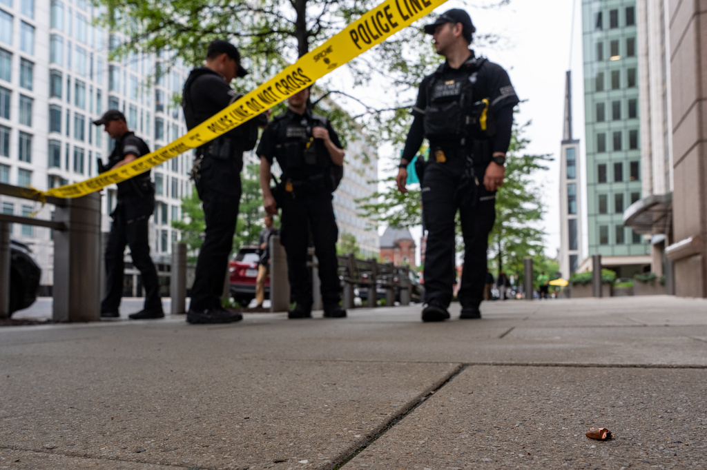 U.S. Secret Service Police officers place crime scene tape after a copper jacket of a bullet was found near the scene of a shooting close to the White House, Sunday, May 24, 2026, in Washington.