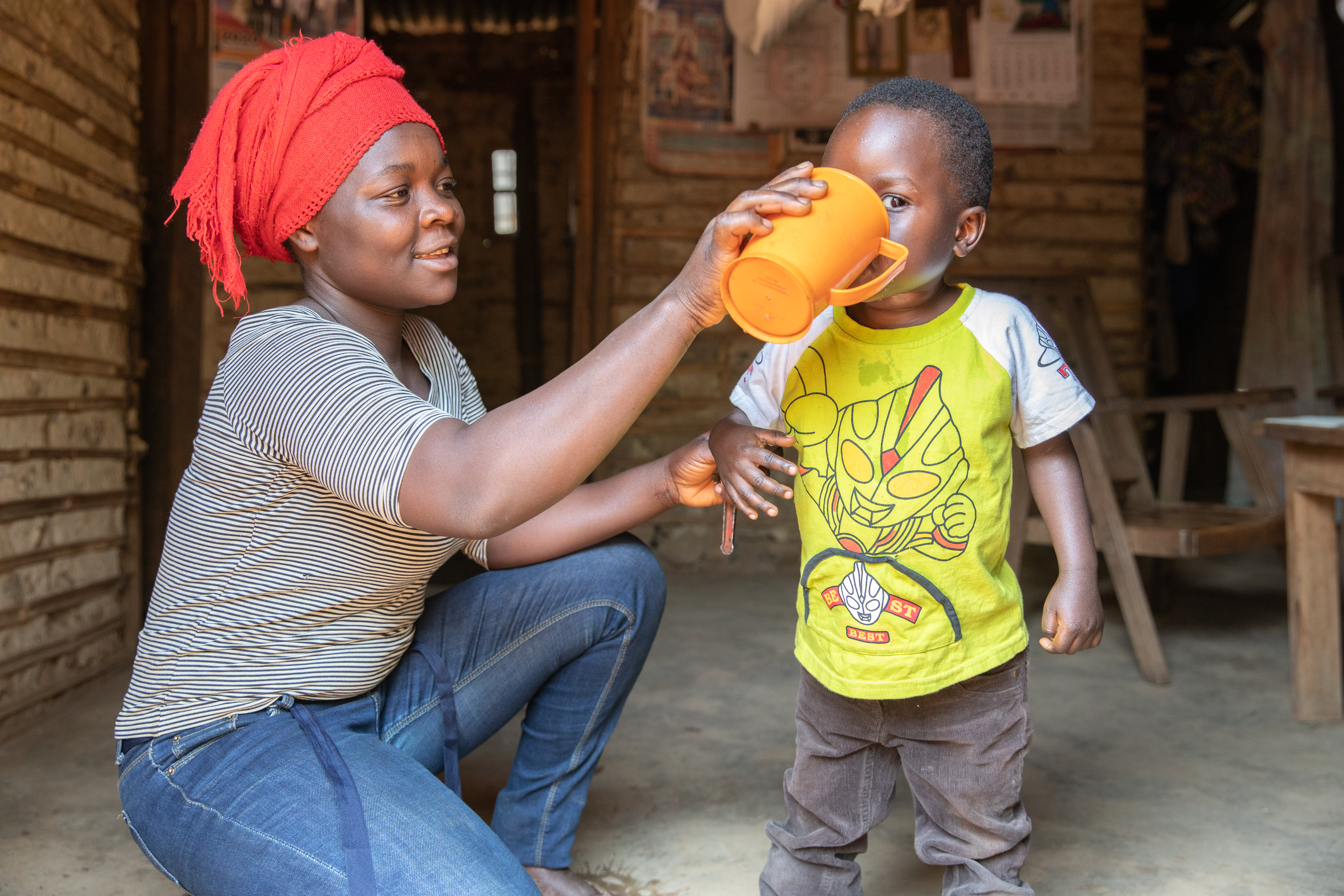 A boy drinks water provided by a Mercy Corps water tap.