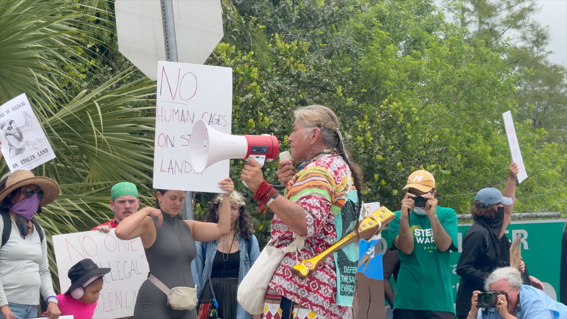 One protester uses a megaphone to express opposition to the construction of "Alligator Alcatraz".