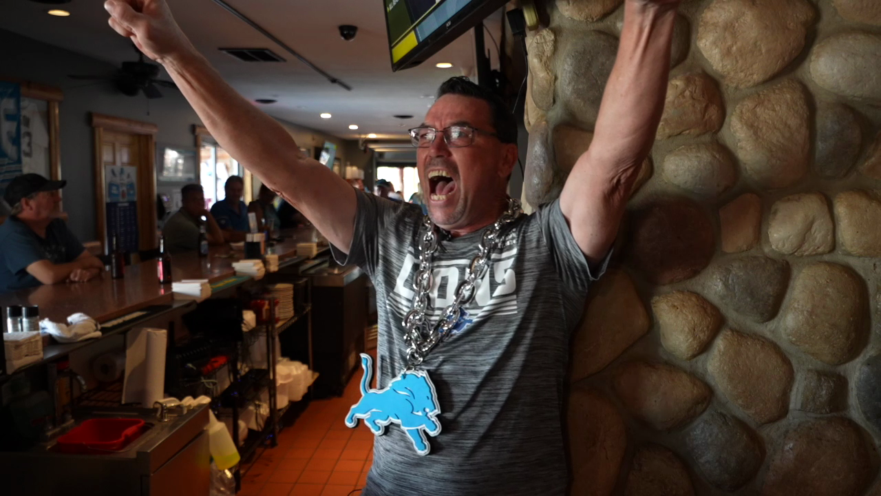 Ryan's Roadhouse bartender Jeff Falor celebrates the Lions' big win over the Chicago Bears