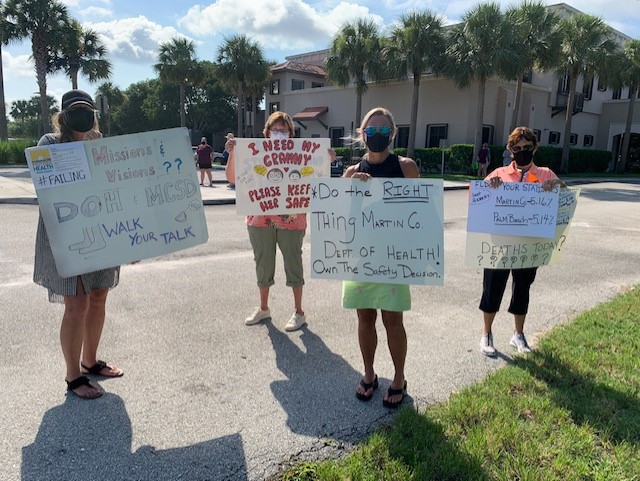 Teachers hold signs at Martin County protest