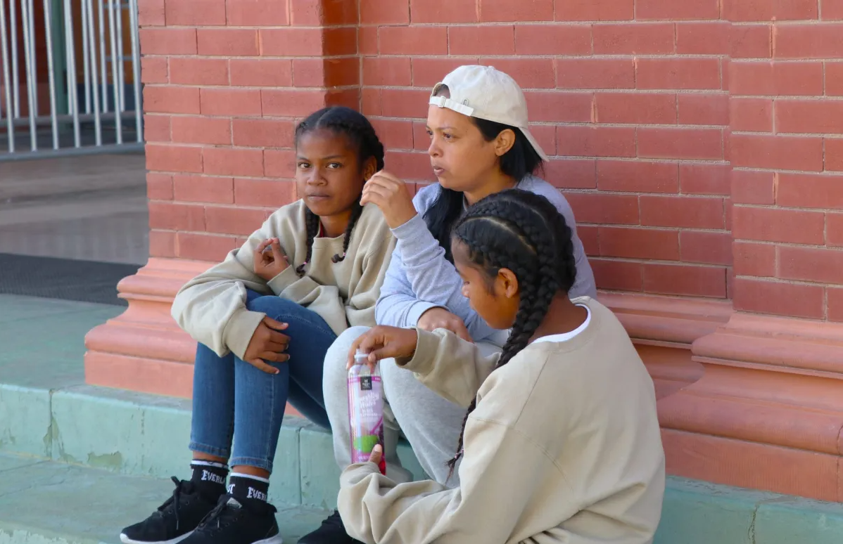 Genesis, center, and her daughters left Venezuela on Aug. 3, arriving at the El Paso-Juarez border in early December. A paperwork mixup is preventing them from leaving El Paso, where they wait at the Union Depot as other migrant families board buses to Denver and other cities.