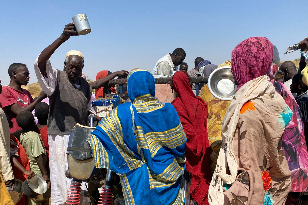 Sudanese who fled el-Fasher city, after Sudan's paramilitary forces killed hundreds of people in the western Darfur region, crowd to receive food at their camp in Tawila, Sudan, Sunday, Nov. 2, 2025. 