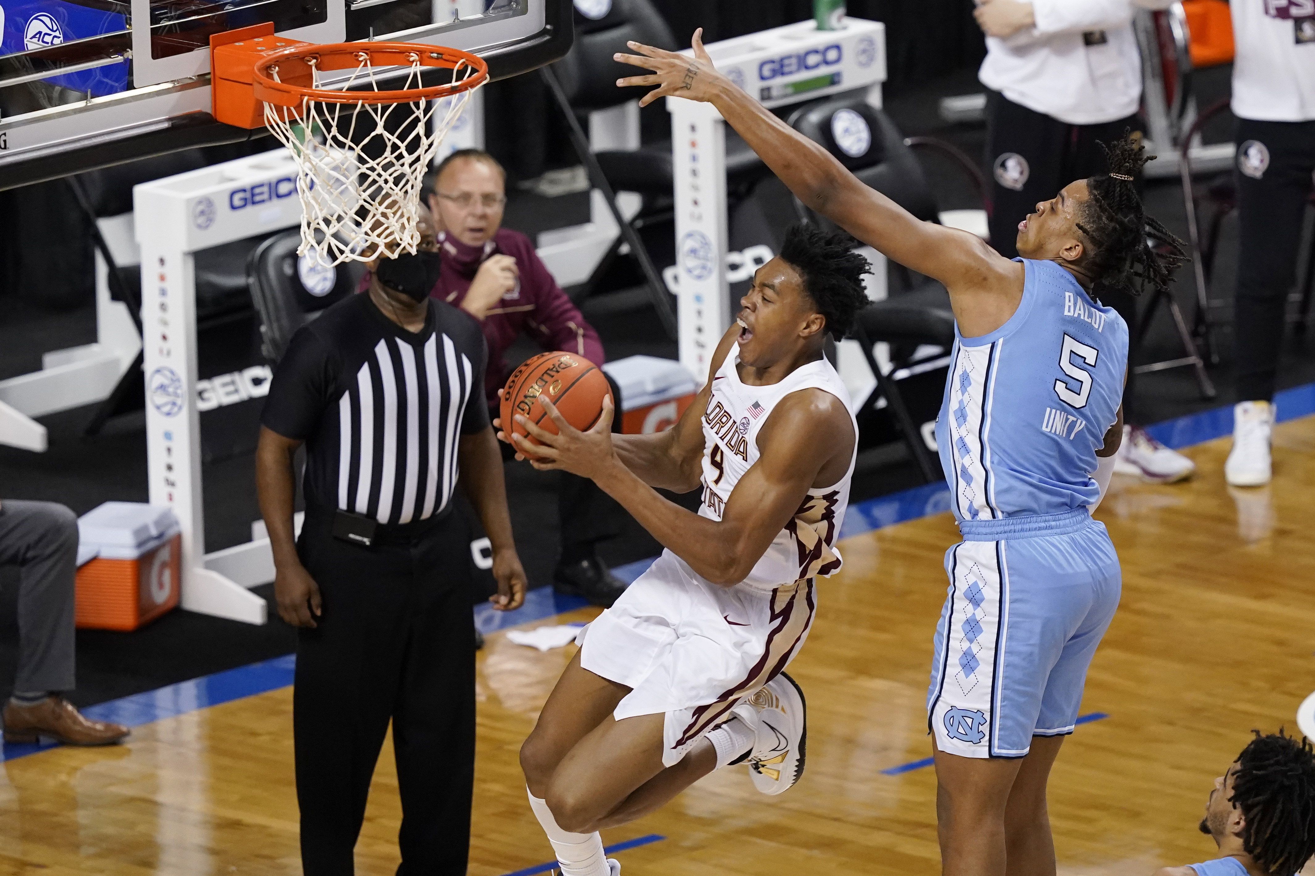Florida State Seminoles guard Scottie Barnes drives to basket vs. North Carolina Tar Heels forward Armando Bacot in 2021 ACC Tournament