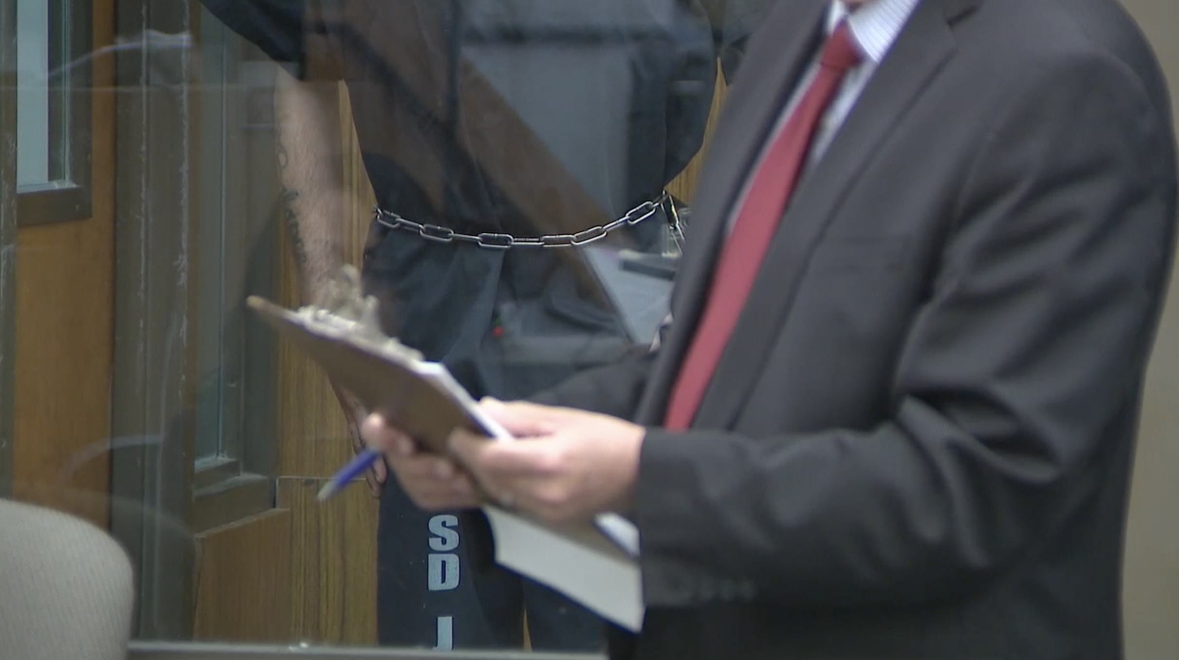 Pope stood motionless behind a protective wall out of sight from most of the courtroom. 