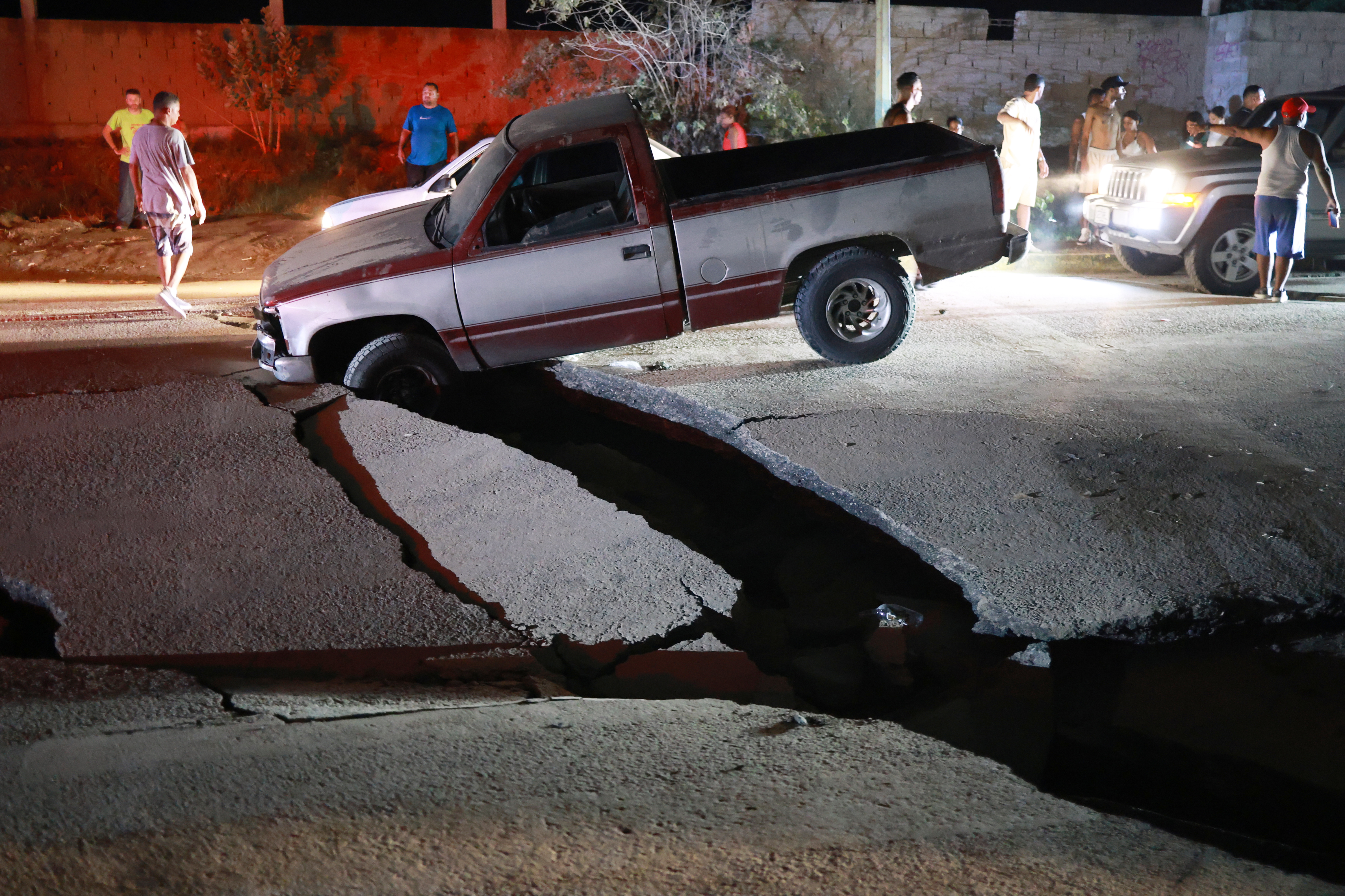 A vehicle is trapped in a fissure caused by an earthquake in La Guaira, Venezuela, Thursday, June 25, 2026.