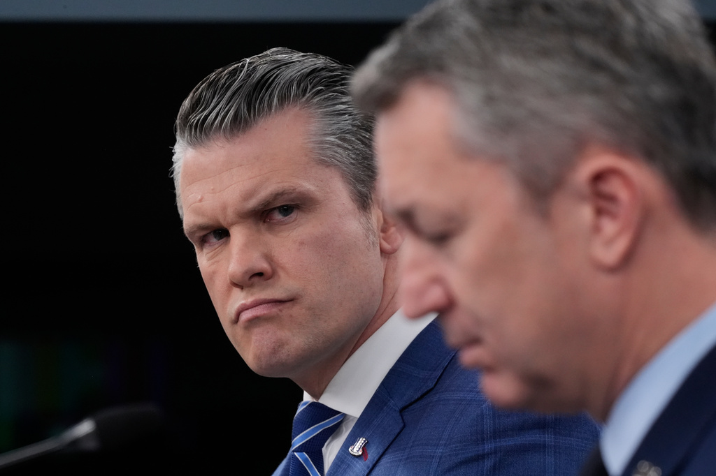 Defense Secretary Pete Hegseth looks toward Chairman of the Joint Chiefs of Staff Gen. Dan Caine, as they speak to members of the media during a press briefing at the Pentagon in Washington, Wednesday, April 8, 2026.