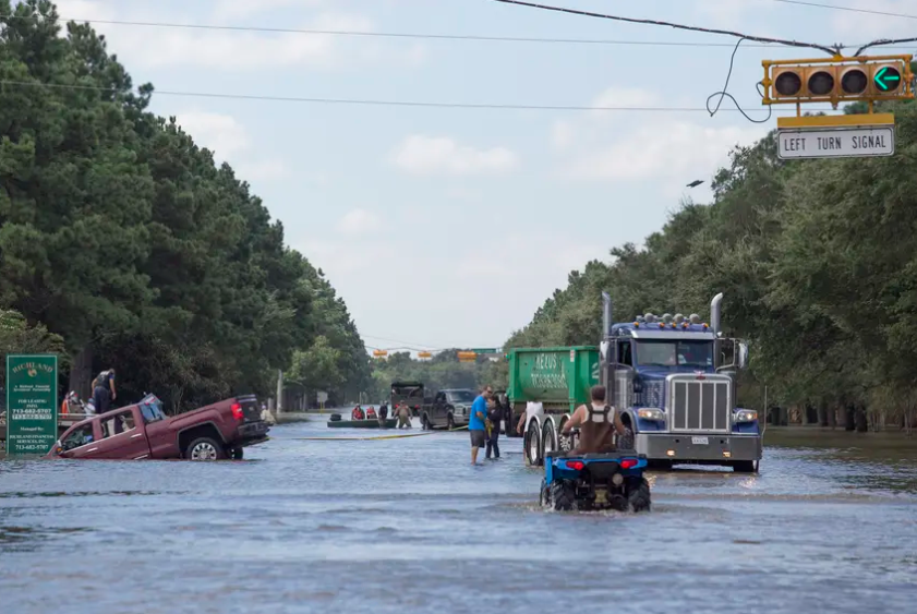 Rescuers and volunteers help evacuate a neighborhood along Eldridge Parkway flooded by waters released from Addicks Reservoir on Aug. 30, 2017, in Houston, added to flooding from Hurricane Harvey. 