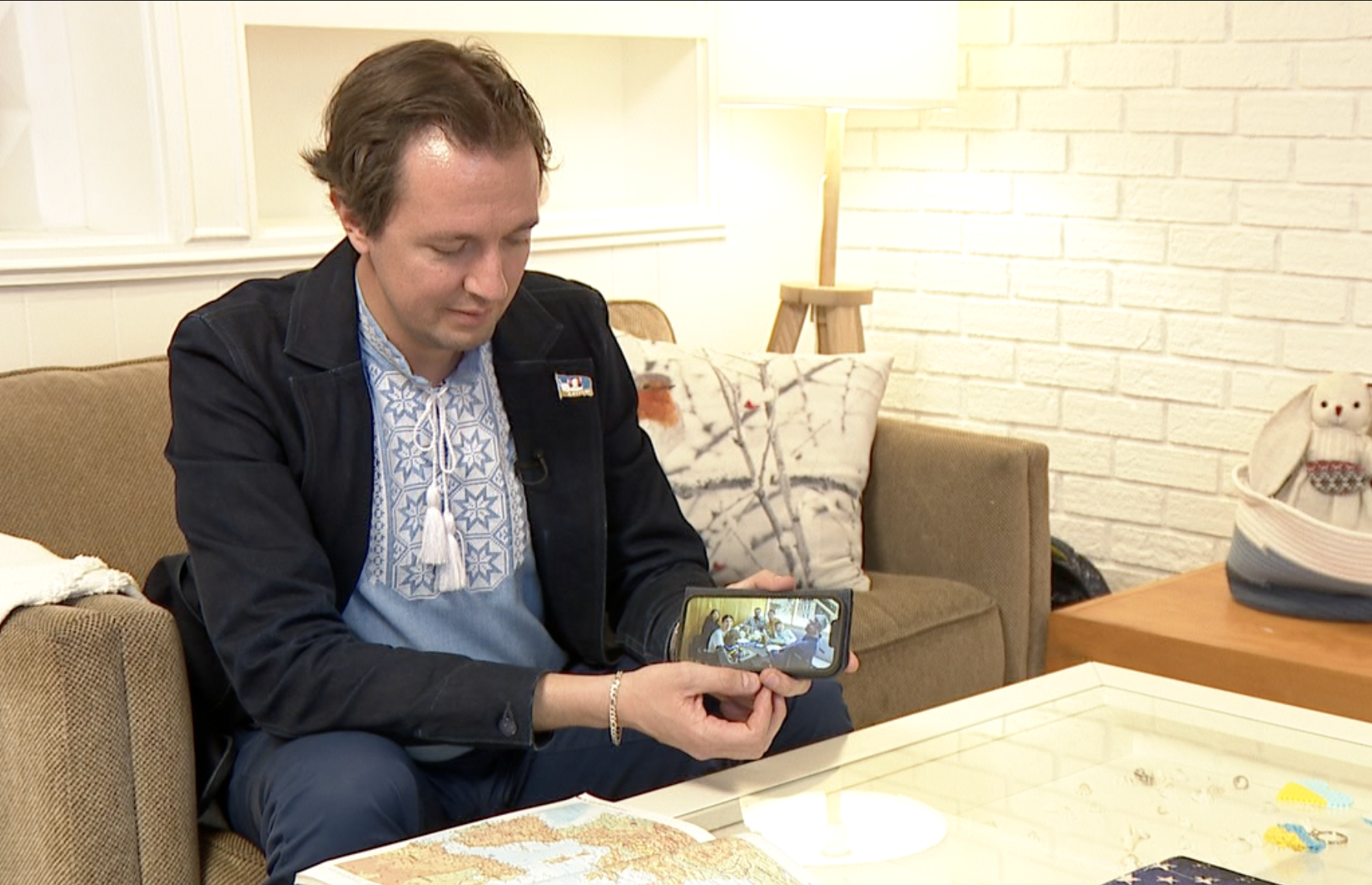 Michael Wynar shows picture of family now safe outside Ukraine 