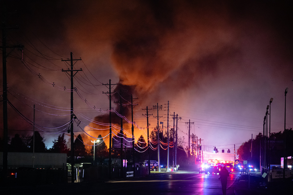 Plumes of smoke rise from the area of a UPS cargo plane crash at Louisville Muhammad Ali International Airport, on Tuesday, Nov. 4, 2025, in Louisville, Ky.