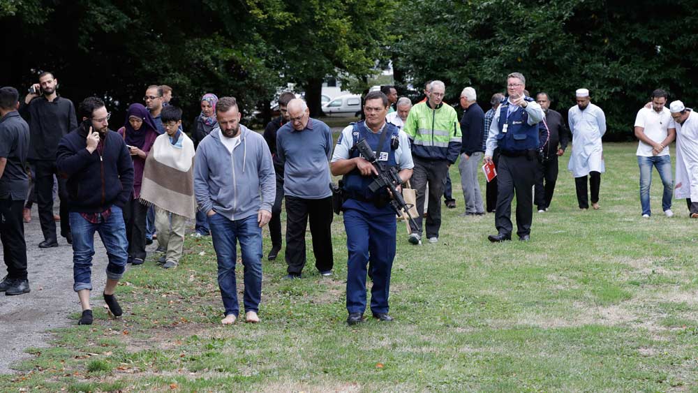 Police escort witnesses away from a mosque in central Christchurch, New Zealand, Friday, March 15, 2019. Multiple people were killed in mass shootings at two mosques full of people attending Friday prayers, as New Zealand police warned people to stay indoors as they tried to determine if more than one gunman was involved. (AP Photo/Mark Baker)