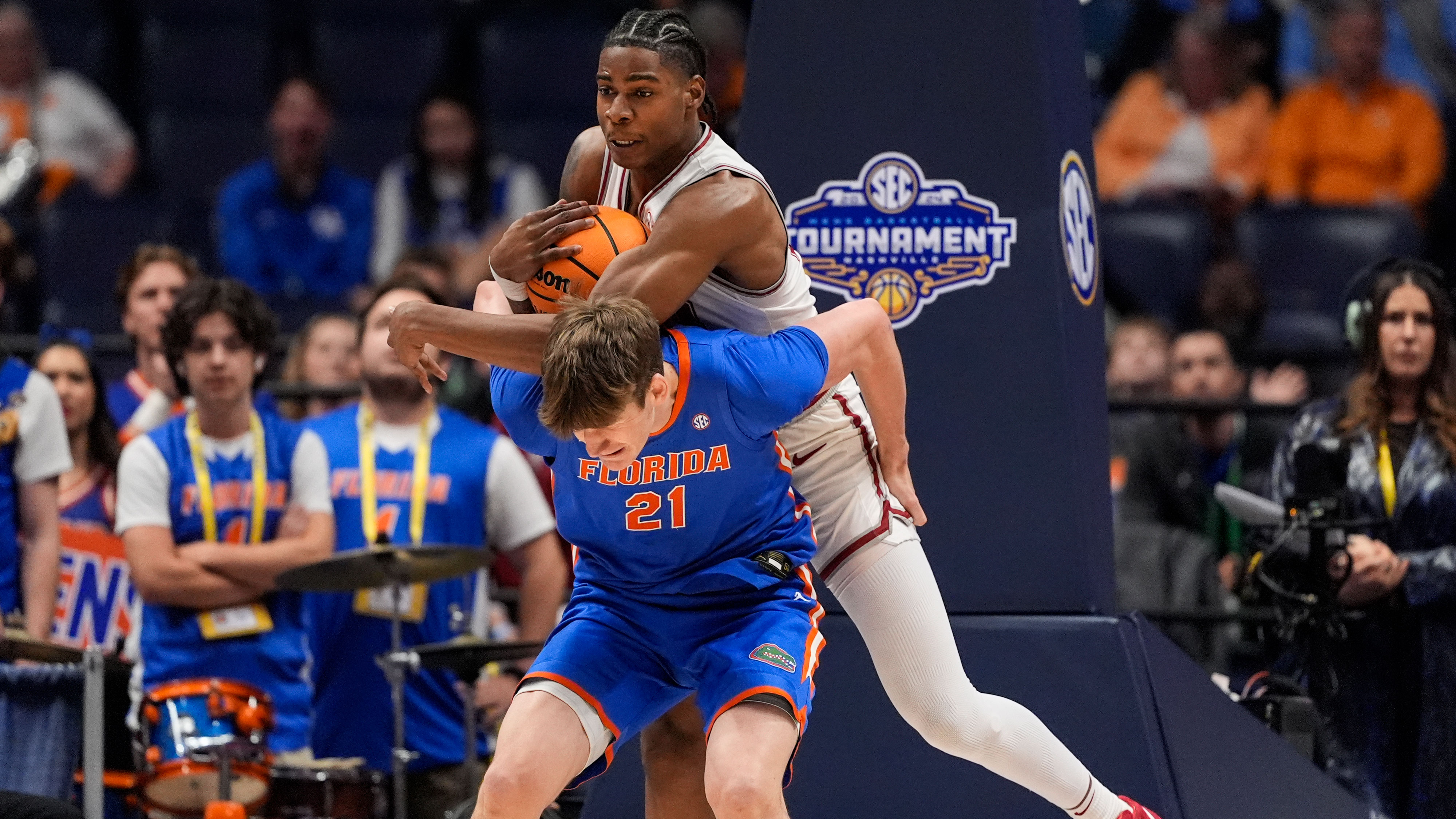 Alabama Crimson Tide forward Nick Pringle fouls Florida Gators forward Alex Condon as he comes down with rebound during first half of SEC Tournament, March 15, 2024