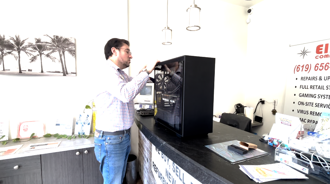 Nathan Hourani is looking at a gaming device for one of his customers. 