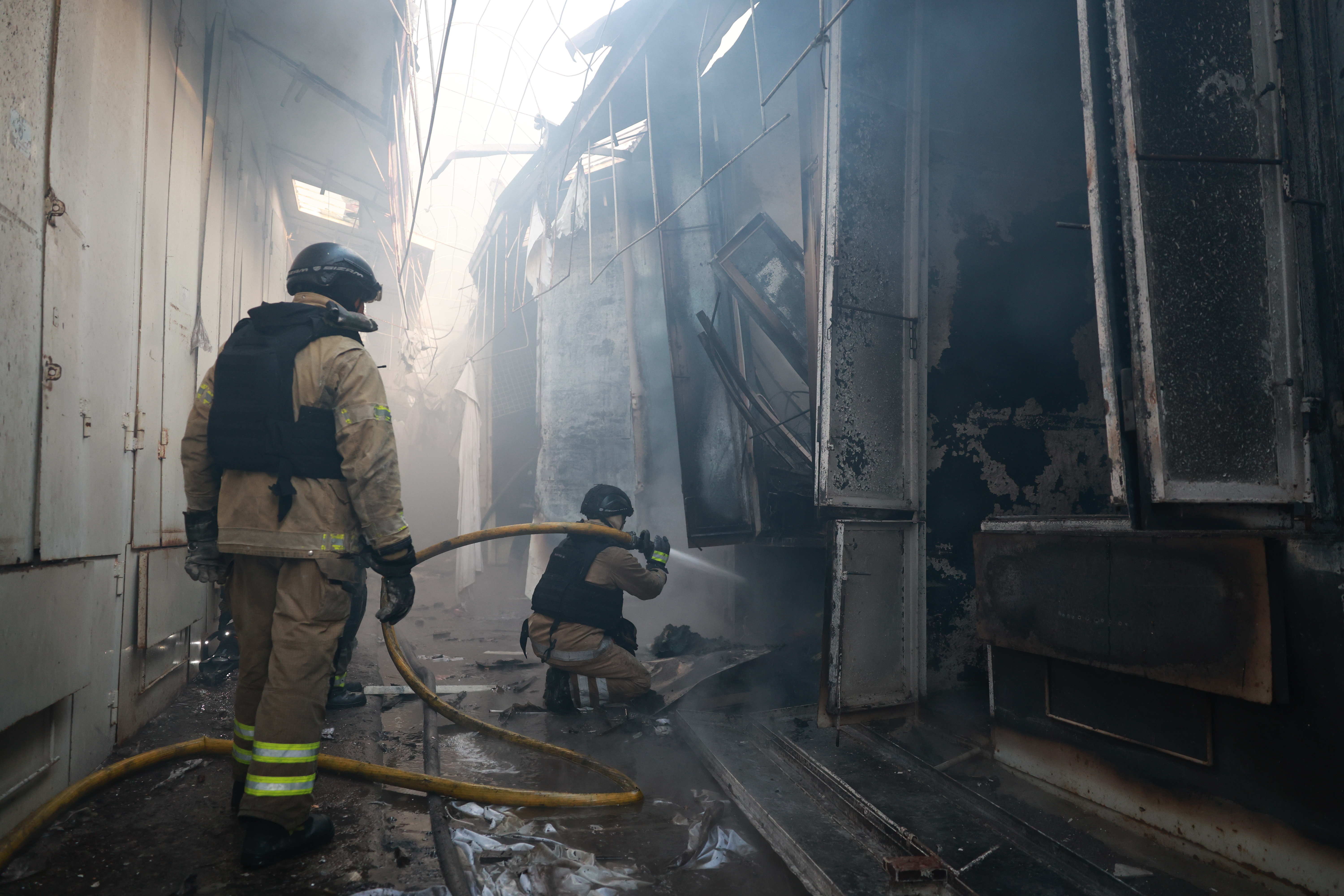 Rescue workers put-out a fire of the central market damaged in a Russian strike on Zaporizhzhia, Ukraine, on Saturday, Sept. 26, 2026.