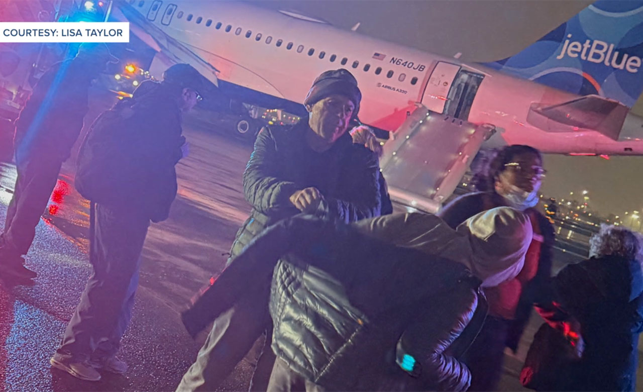 Passengers exit a JetBlue flight that departed Newark for Palm Beach International Airport on Feb. 18, 2026, after it had to make an emergency landing.