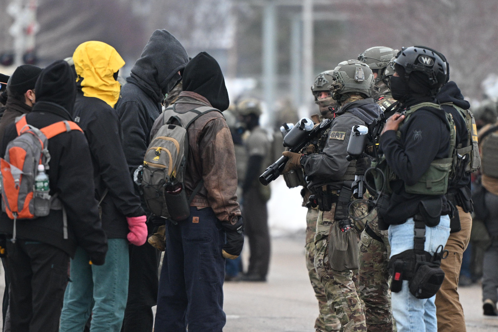 Protesters confront federal agents outside the Bishop Henry Whipple Federal Building, Thursday, Jan. 8, 2026, in Minneapolis, Minn.