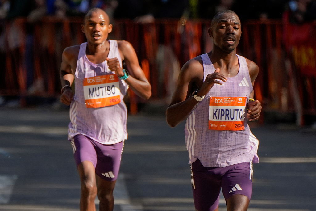 Benson Kipruto and Alexander Mutiso, both of Kenya, make their way through Central Park during the New York City Marathon, Sunday, Nov. 2, 2025, in New York.