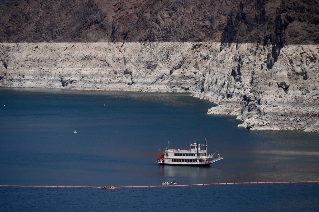 A paddle boat in Lake Mead near the Hoover Dam, far below the bathtub ring of light minerals indicating the lack of water, near Boulder City, Nev., on Friday, Aug. 7, 2026.