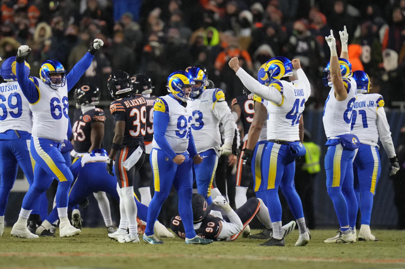 Los Angeles Rams kicker Harrison Mevis, center, reacts with holder Ethan Evans, center right, and teammates after booting a game-winning field goal during overtime of an NFL football divisional playoff game Sunday, Jan. 18, 2026, in Chicago, Ill.