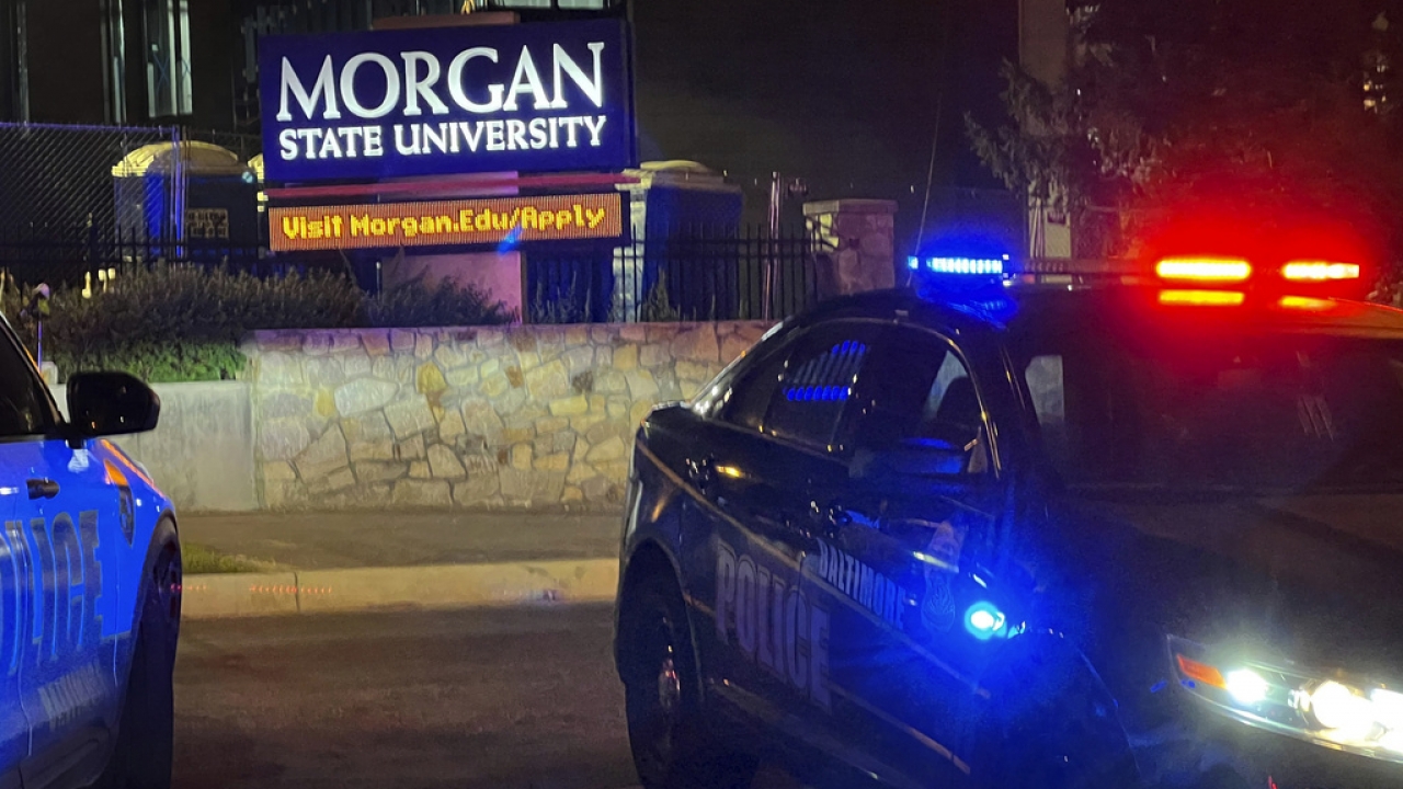 Police car in front of Morgan State University campus sign