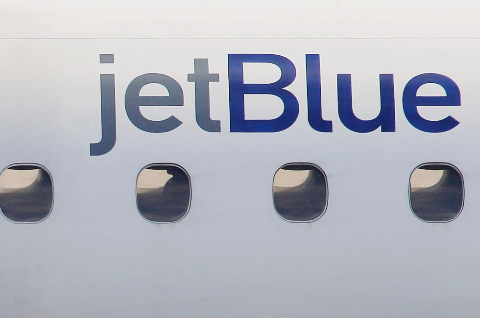 A JetBlue logo is displayed on the side of a jet as it taxis at Boston’s Logan International Airport, Jan. 20, 2011.