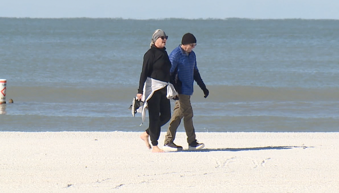 Tourists embrace Florida's chilly weather while locals bundle up