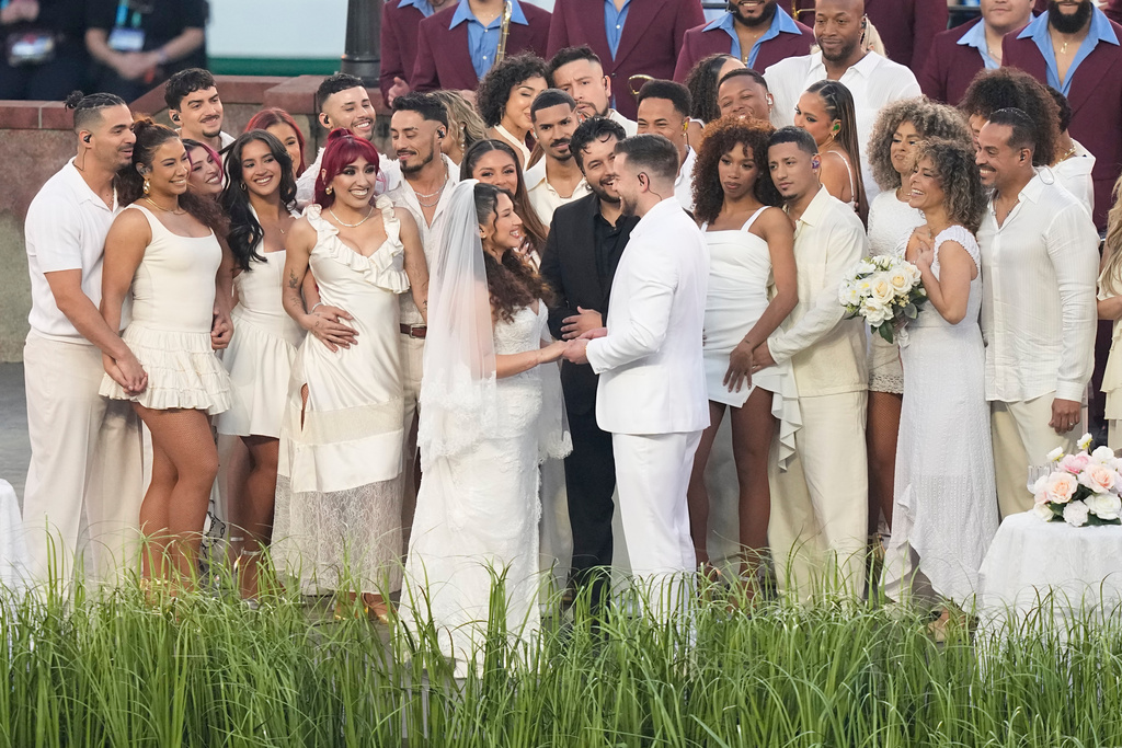 A couple dressed as a bride and groom participate in the Bad Bunny performance during halftime of the NFL Super Bowl 60 football game between the Seattle Seahawks and the New England Patriots, Sunday, Feb. 8, 2026, in Santa Clara, Calif.