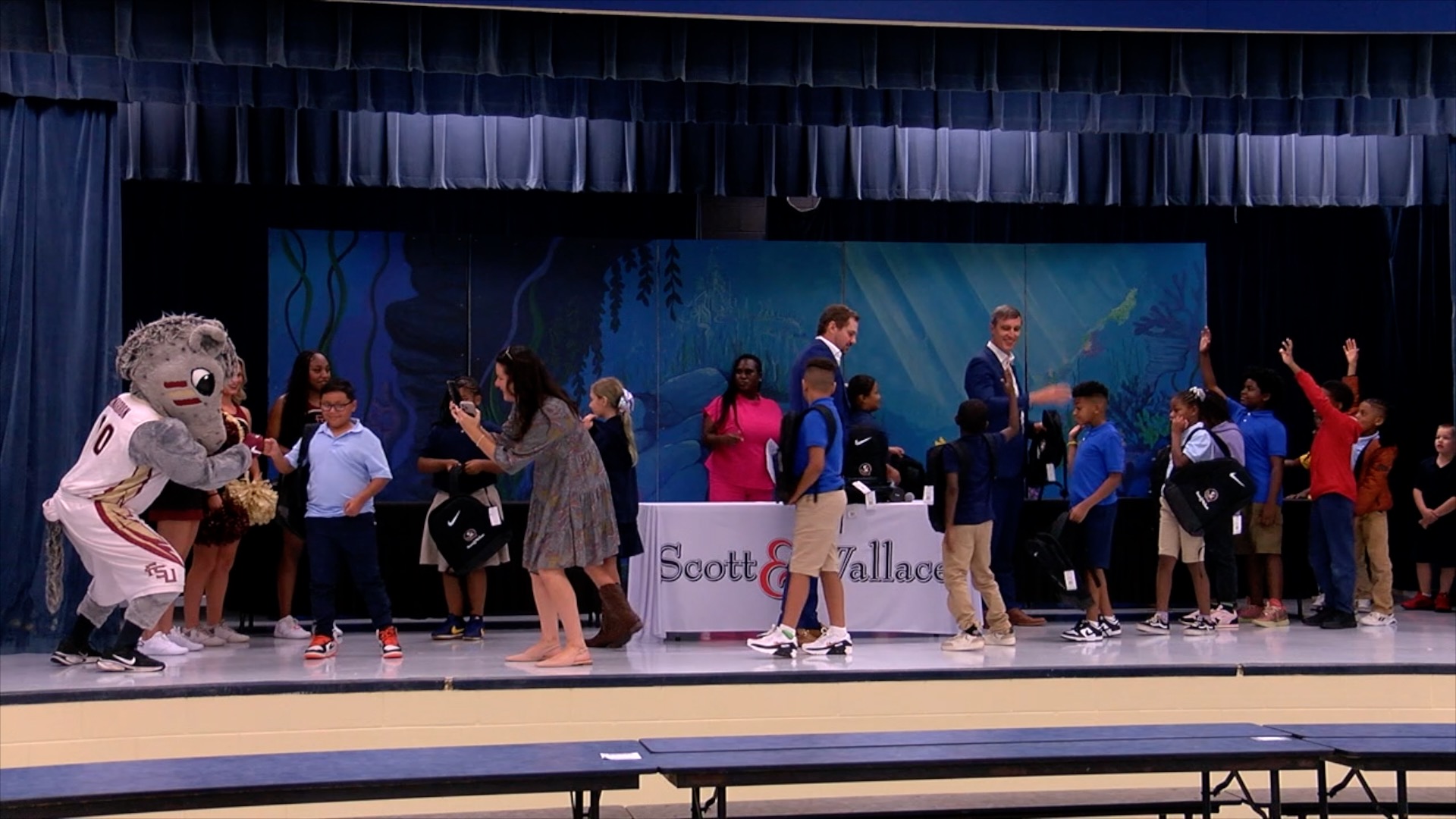 Students walking through the giveaway line