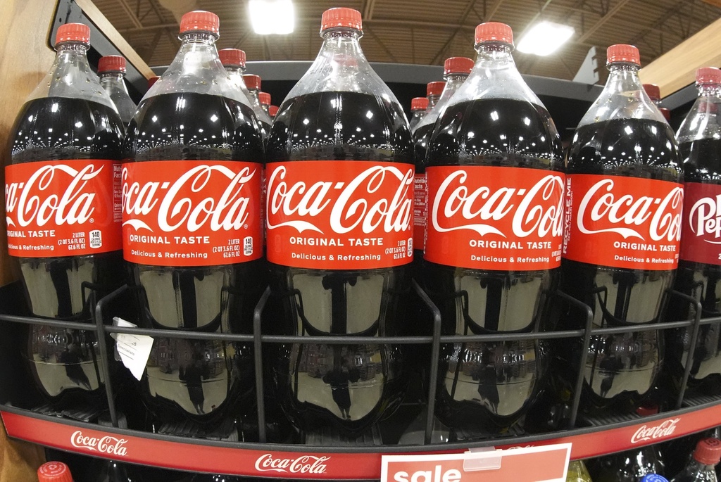 A shelf of Coca-Cola 2 liter bottles for sale.