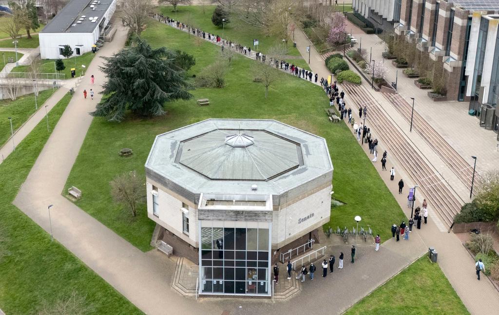 Students queue for antibiotics outside a building at the University of Kent, following an outbreak of meningitis, in Canterbury, Kent, England, Monday March 16, 2026. 
