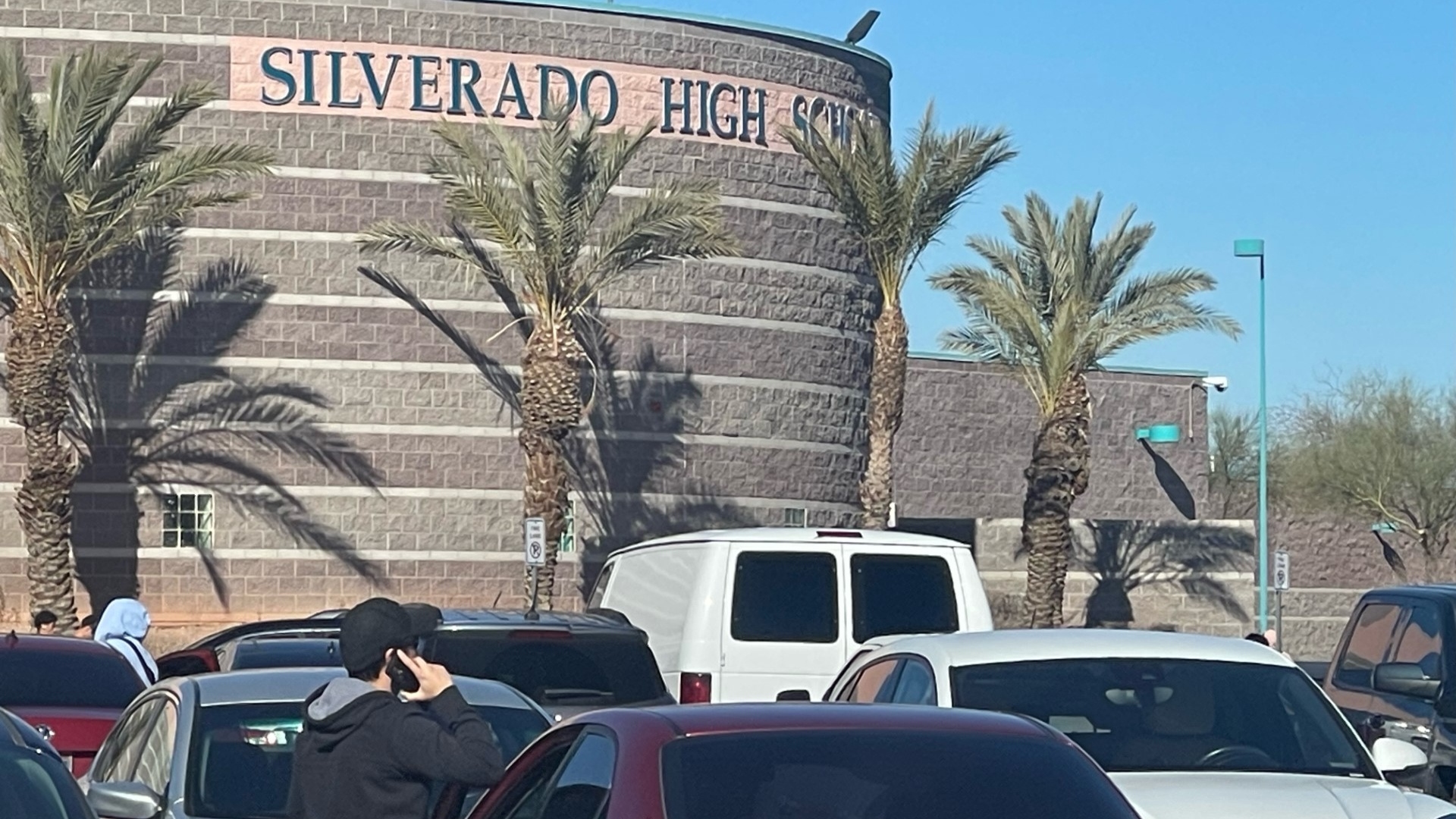 Students make calls outside of Silverado High School after an altercation involving a knife on January 30, 2024.