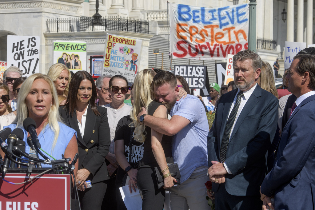 FILE: Brother of Virginia Giuffre, Sky Roberts, center, is embraced by Anouska De Georgiou during a news conference regarding the release of the Jeffrey Epstein files, on Capitol Hill, Wednesday, Sept. 3, 2025, in Washington. 