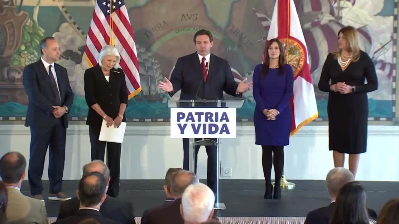 Gov. Ron DeSantis and Lt. Gov. Jeannette Nunez stand in front of 'Patria Y Vida' podium in Miami, Nov. 15, 2021