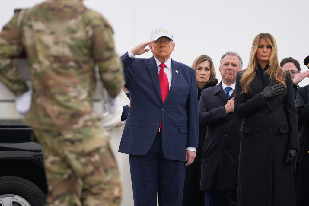 An Army carry team carry a flag-draped transfer case with the remains of U.S. Army Reserve soldier Capt. Cody Khork, 35, of Winter Haven, Fla., who was killed in a drone strike at a command center in Kuwait after the U.S. and Israel launched its military campaign against Iran, past President Donald Trump and first lady Melania Trump during a casualty return, Saturday, March 7, 2026, at Dover Air Force Base, Del. 