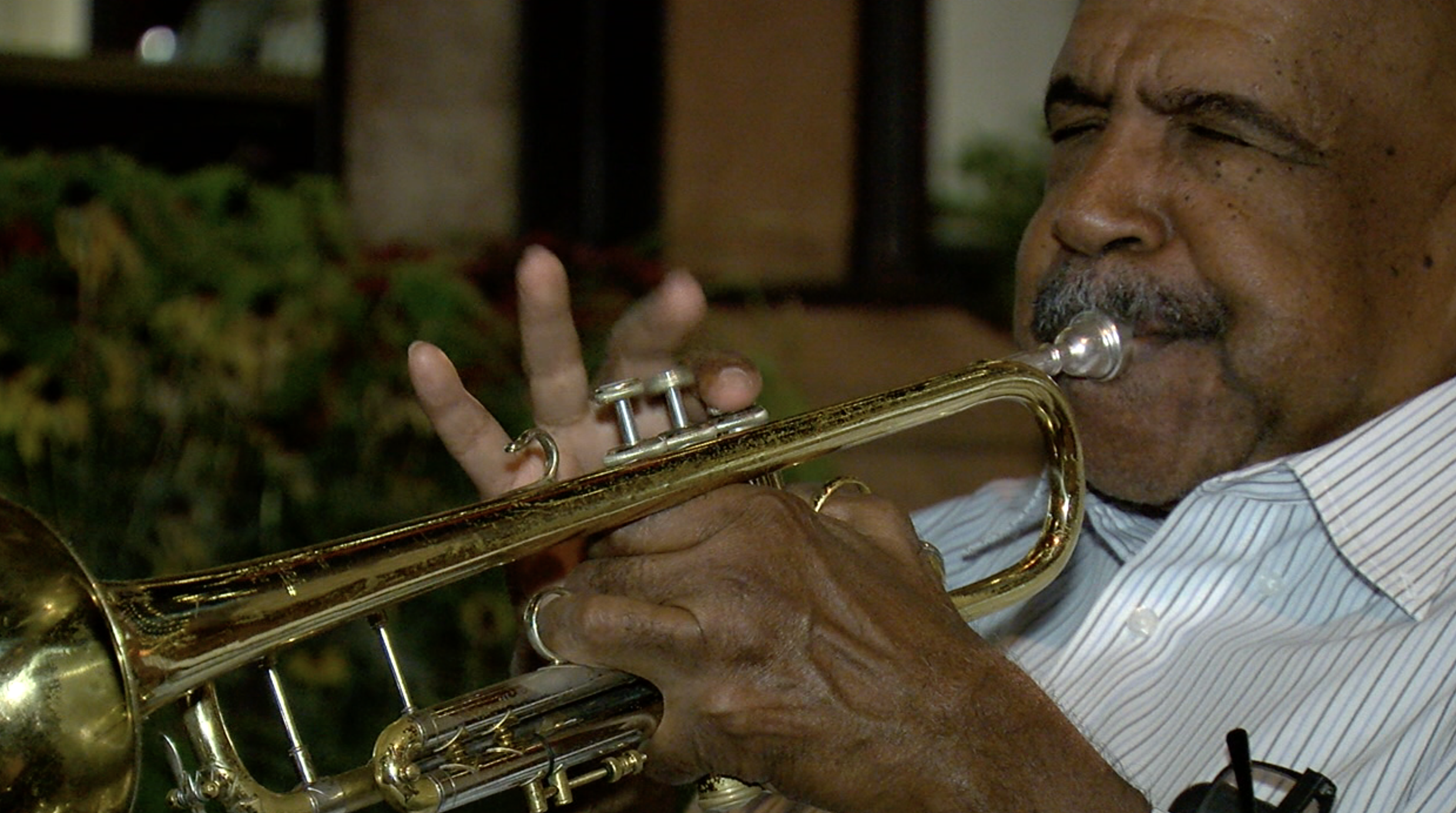 Dr. Hugh Ragin playing the trumpet in Larimer Square