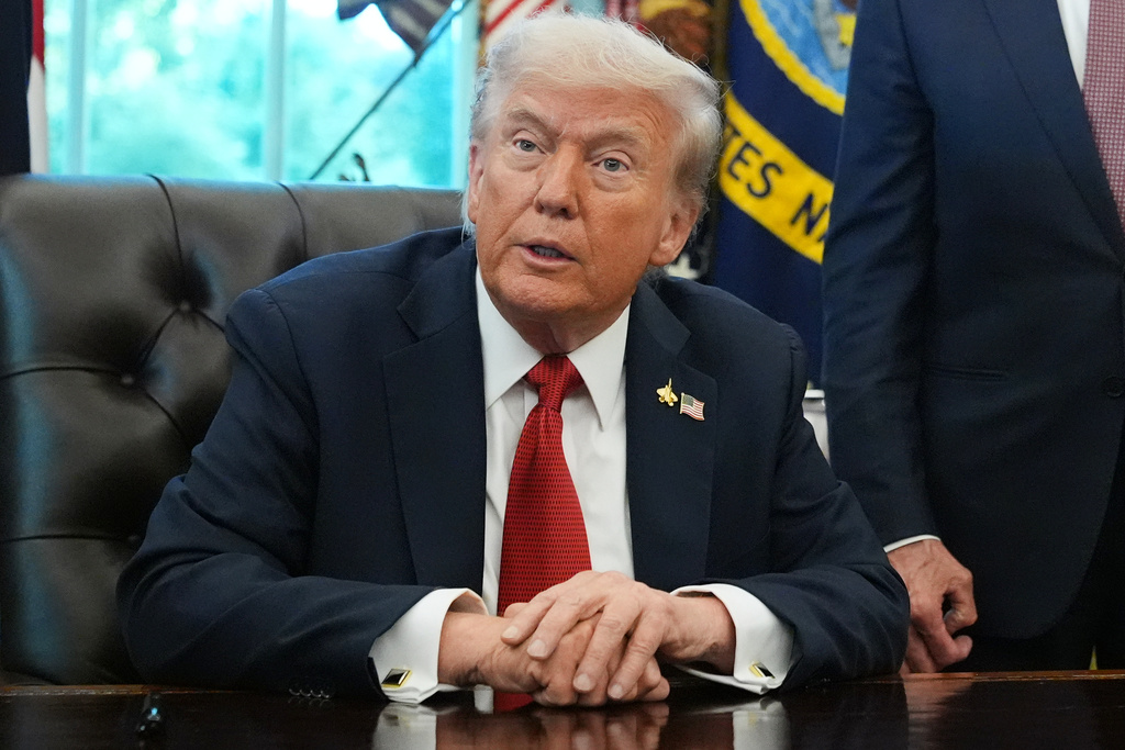 President Donald Trump speaks to reporters before signing an executive order in the Oval Office at the White House, Monday, Oct. 6, 2025, in Washington. 