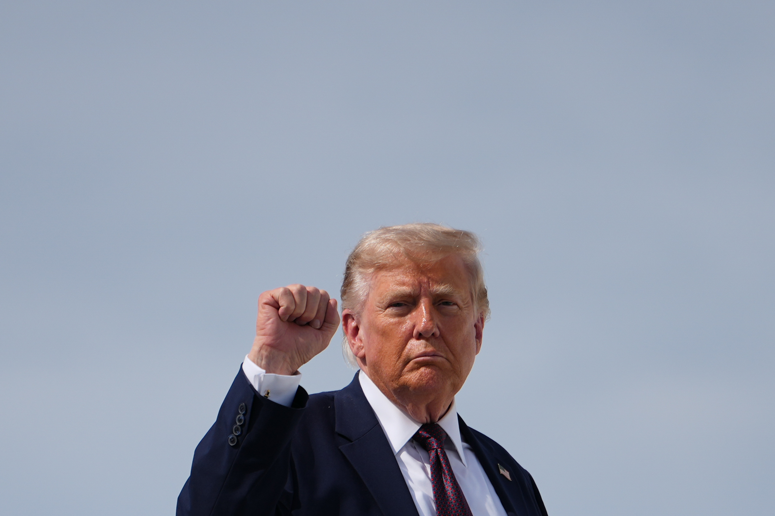 President Donald Trump raises his fist while boarding Air Force One at Reading Regional Airport, Tuesday, June 23, 2026, in Reading, Pa.