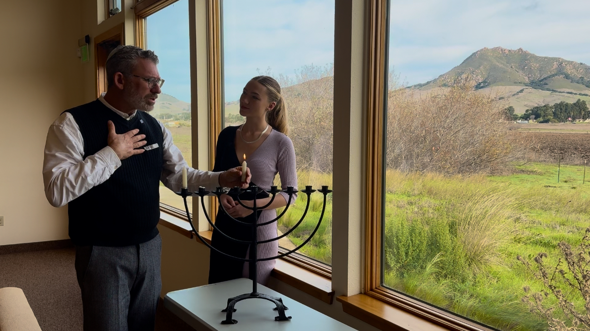 Community reporter Shannon MacNeil learns about lighting the menorah with Rabbi Micah Hyman at Congregation Beth David in San Luis Obispo.