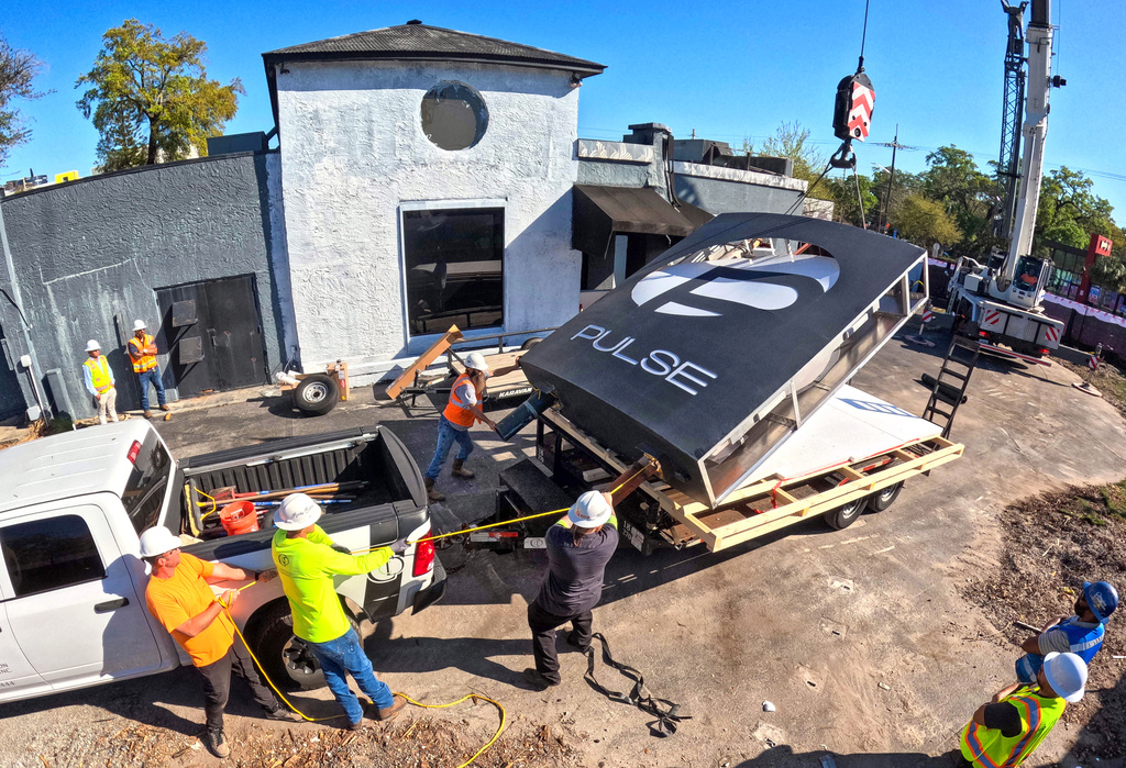 The sign for the Pulse nightclub is removed by workers, Wednesday, March 11, 2026, at the memorial site of the 2016 mass shooting in Orlando, Fla., that killed 49. 