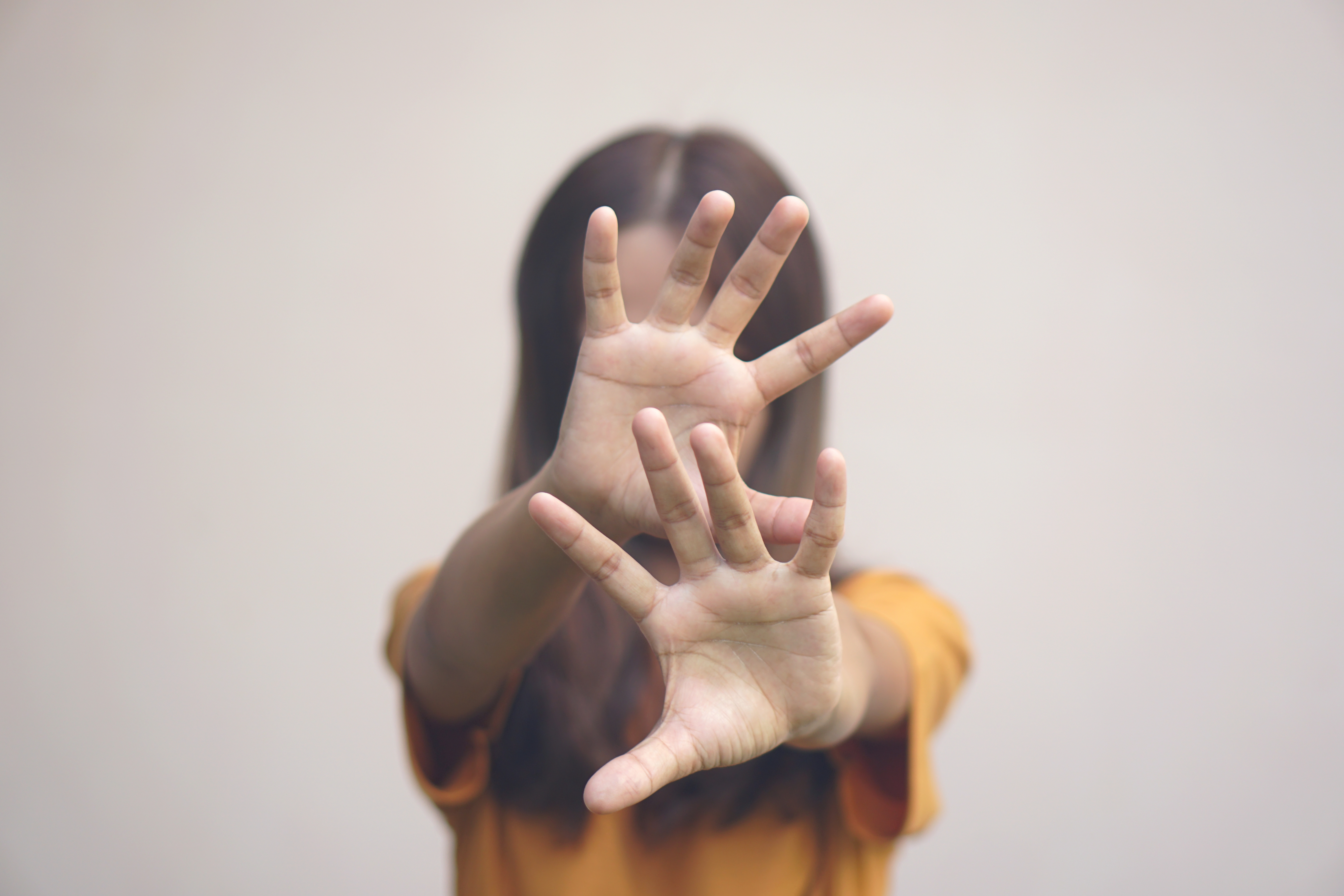 A person covering their face.