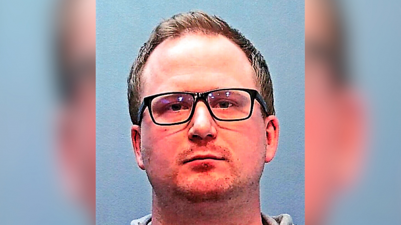 A booking photo provided by the Police Department in Glendale, Colo., shows police officer Nathan Woodyard