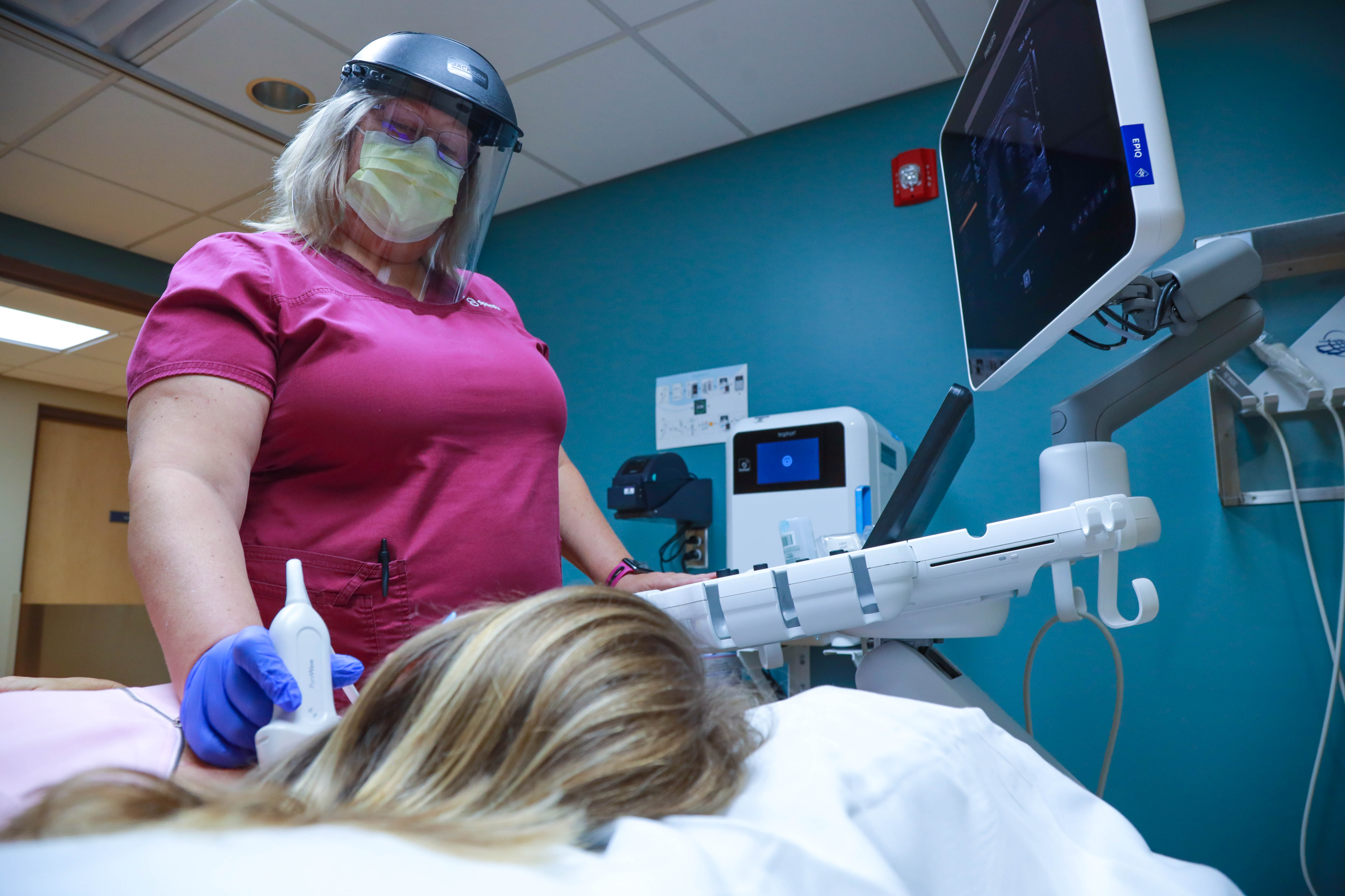 Ultrasound tech looking at patient.JPG