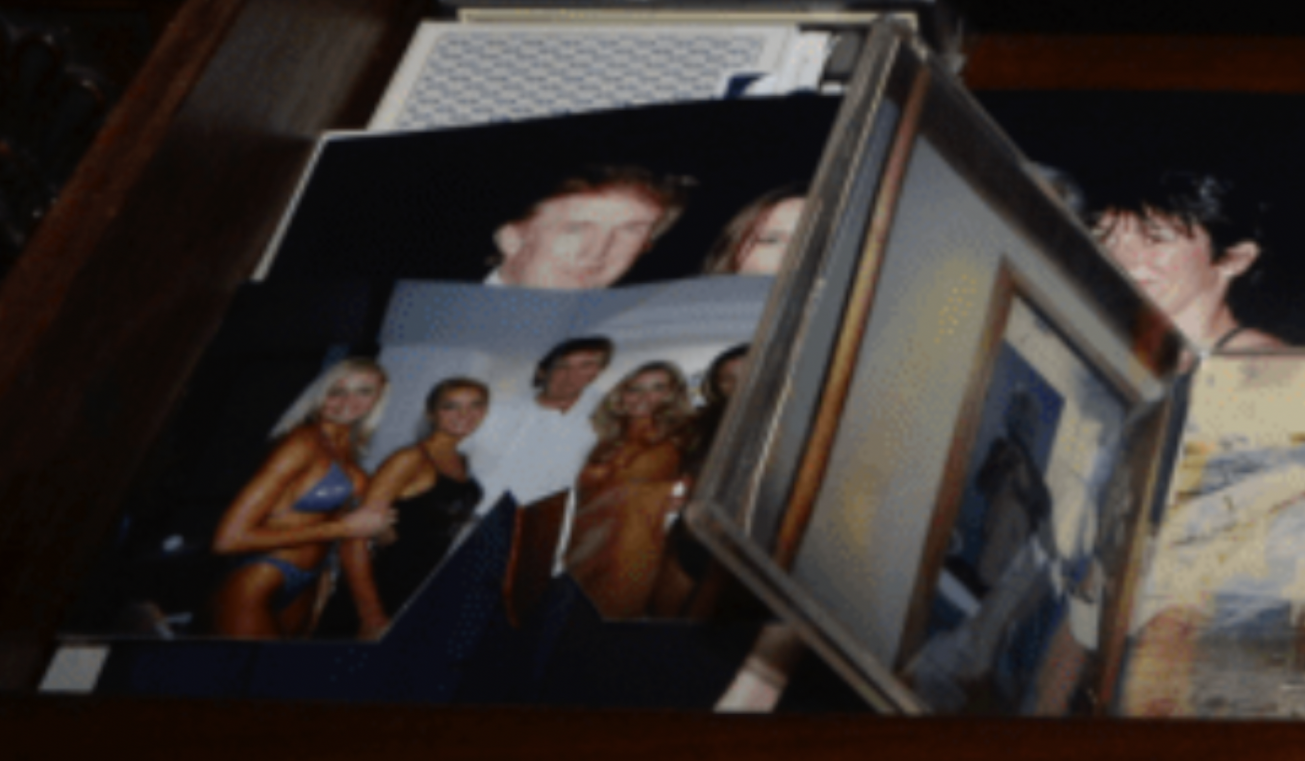 Document from the Department of Justice's release of files related to its investigation into Jeffrey Epstein features two images in a desk that feature Donald Trump.