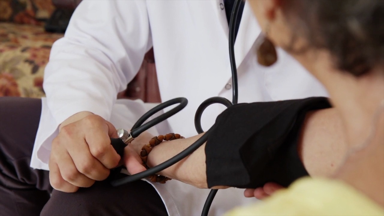 Doctor checking blood pressure
