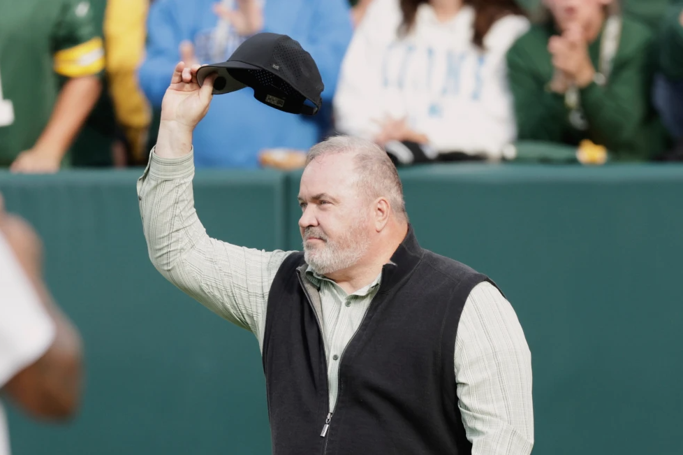 Former Green Bay Packers head coach Mike McCarthy waves during halftime of an NFL football game against the Detroit Lions Sunday, Sept. 7, 2025, in Green Bay.
