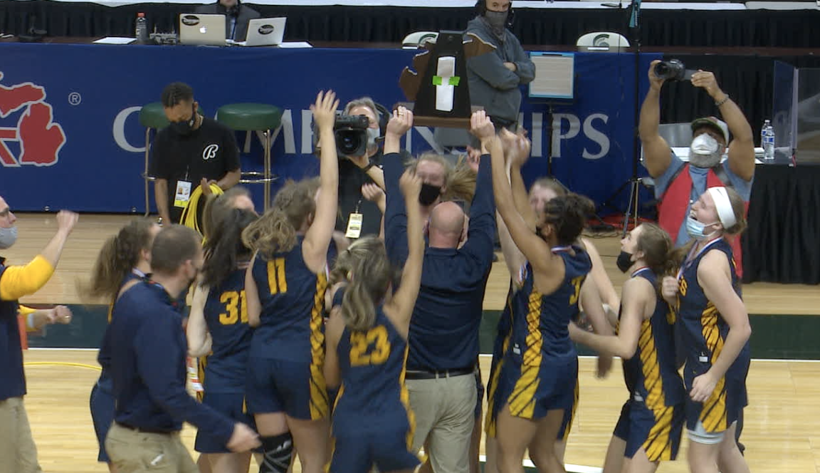Casey Glass hoists trophy after Hudsonville state title
