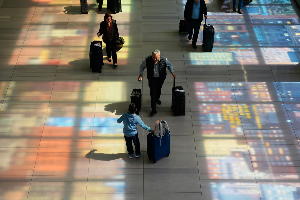 Stained-glass windows cast colorful shadows at LaGuardia Airport in New York, Monday, March 30, 2026.