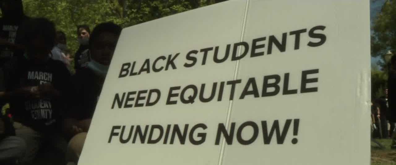 A sign at a Black in School Coalition rally and march at Capitol Park in Sacramento