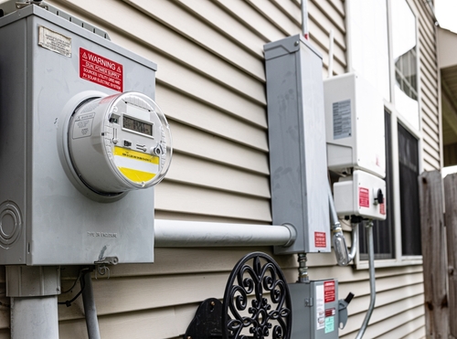 Stock image of an electricity meter on a home.